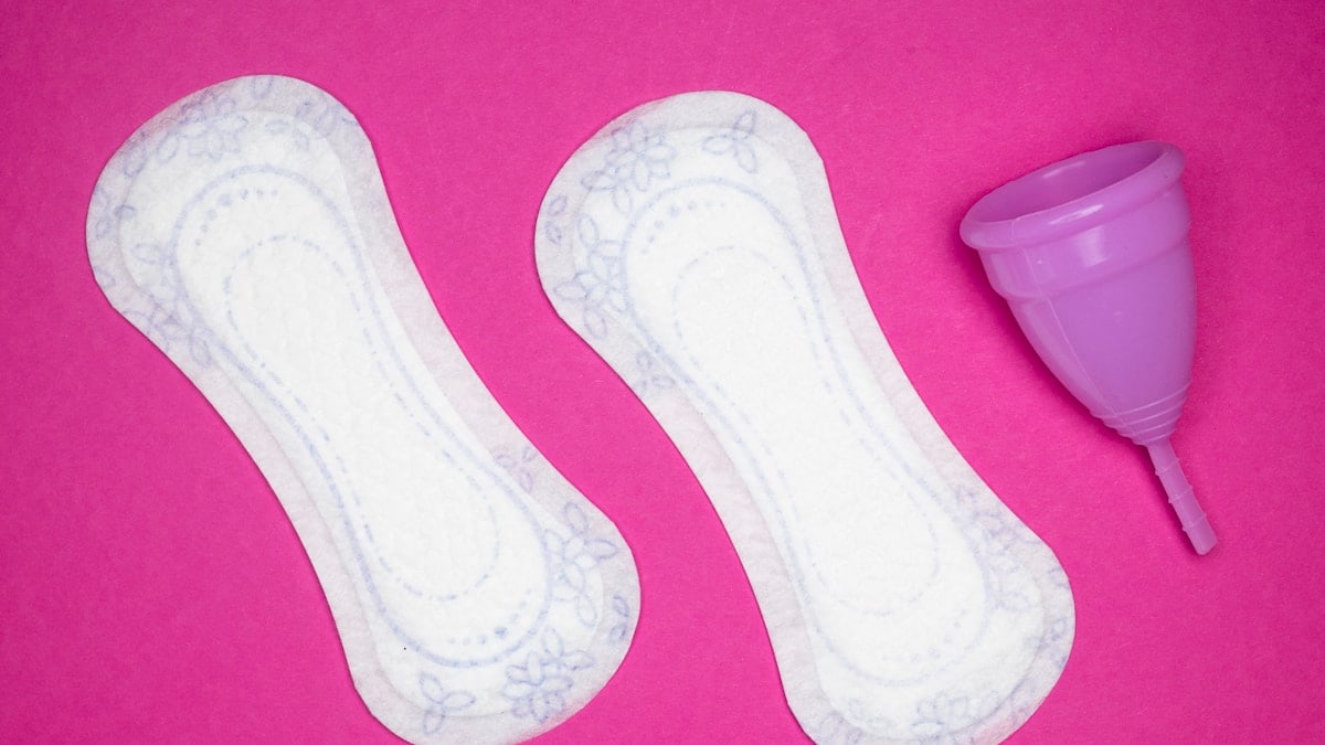 Menstrual health products and supplies (pads, tampons, menstrual cups or reusable cups) on a colorful background.